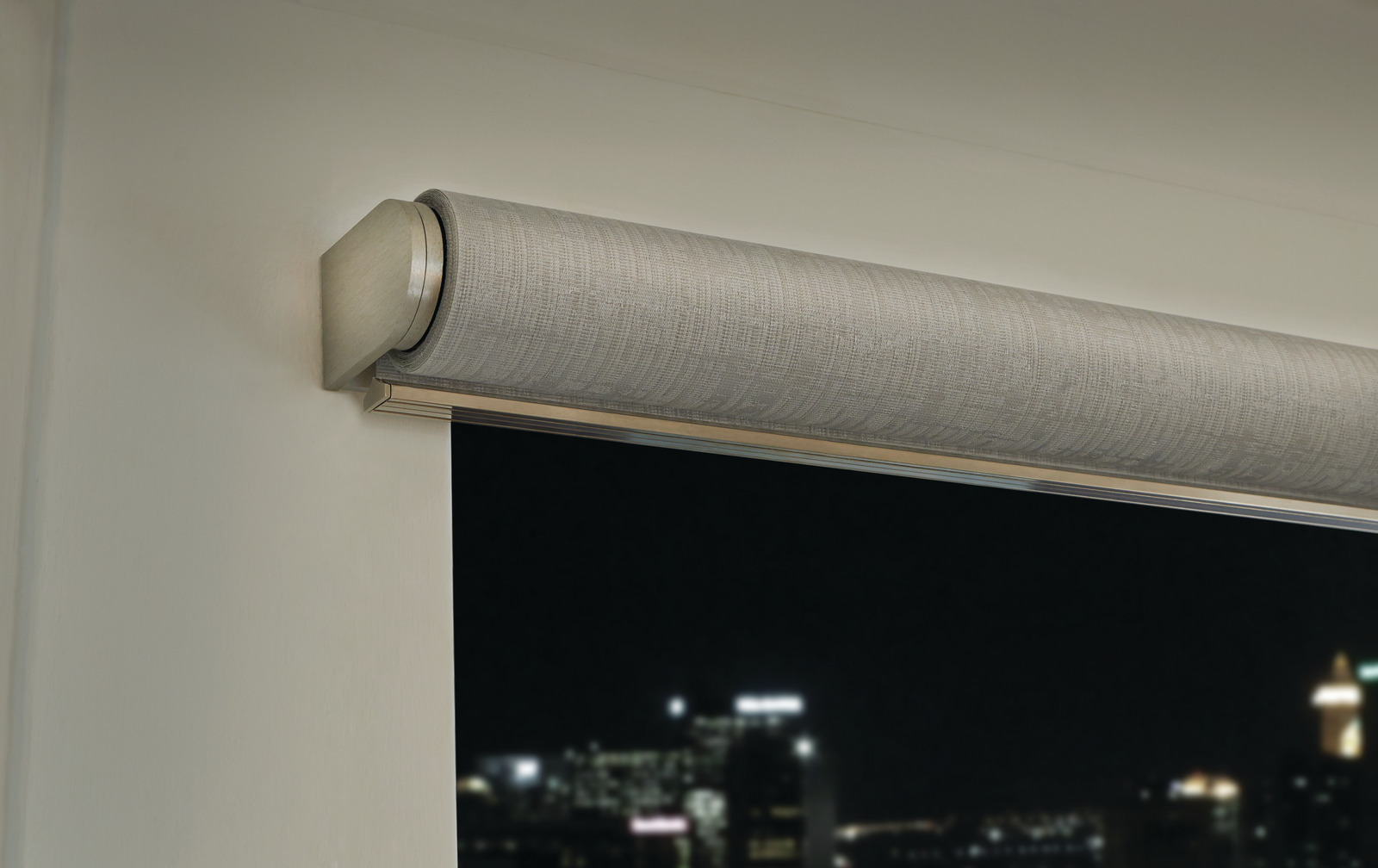 A close view of a Lutron Palladiom roller shade and its exposed bracket