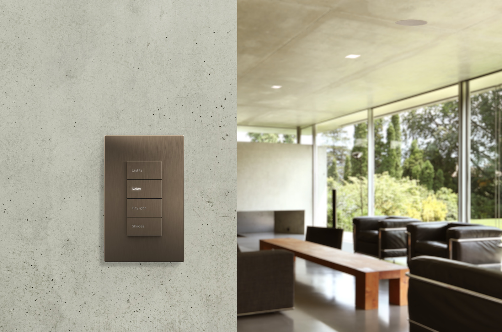 A bronze Savant four-button keypad on a concrete wall beside a daylit living room