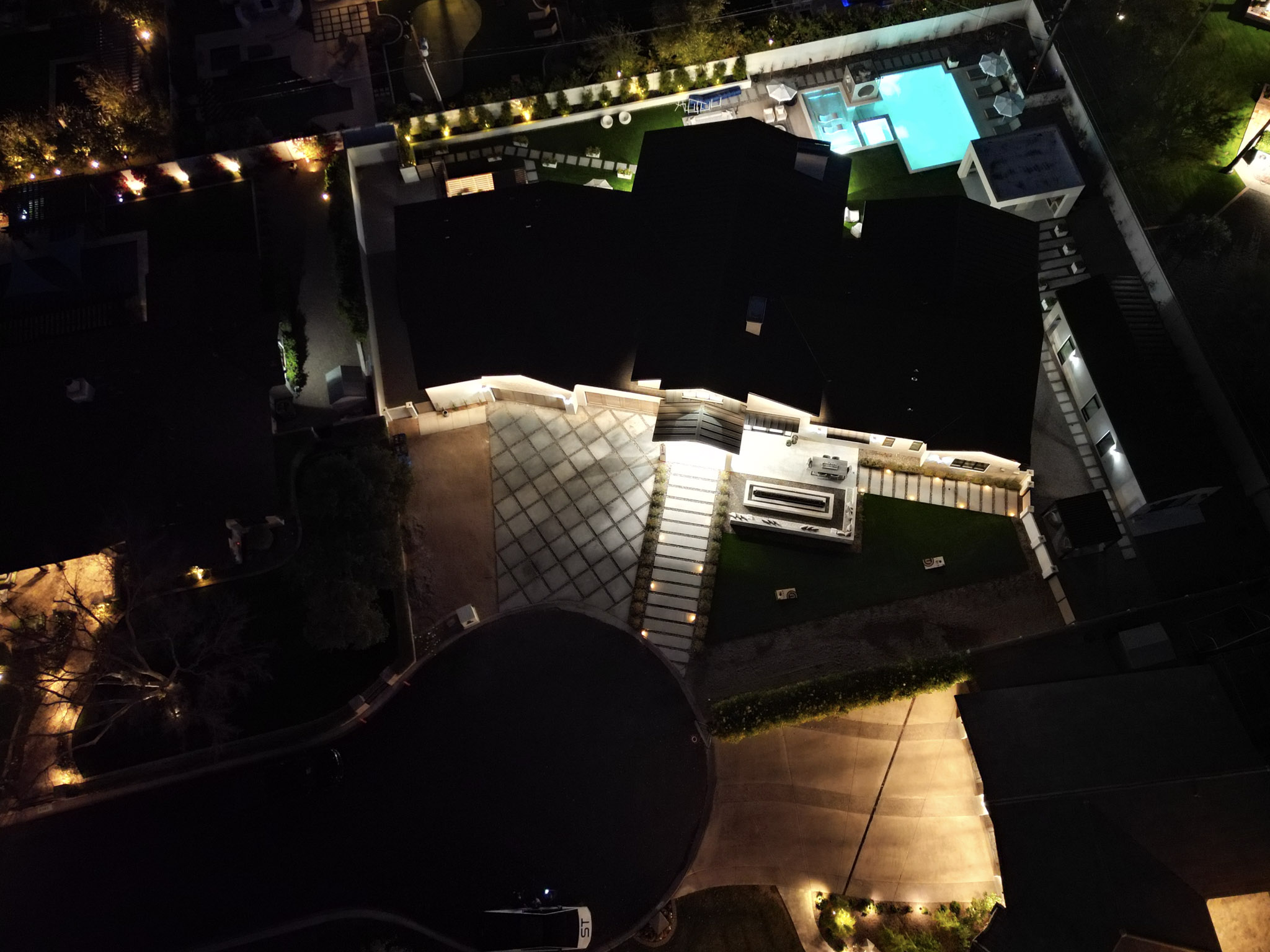 Aerial view of Casa del Norte with illuminated landscaping and pool