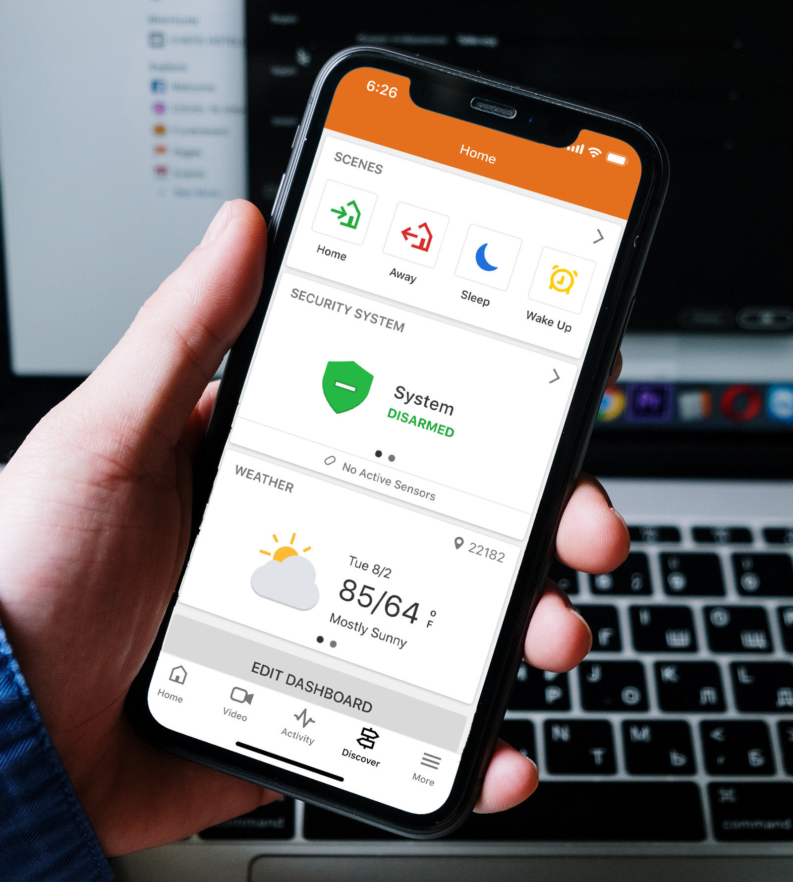 Alarm.com marketing image showing a phone with home status and controls