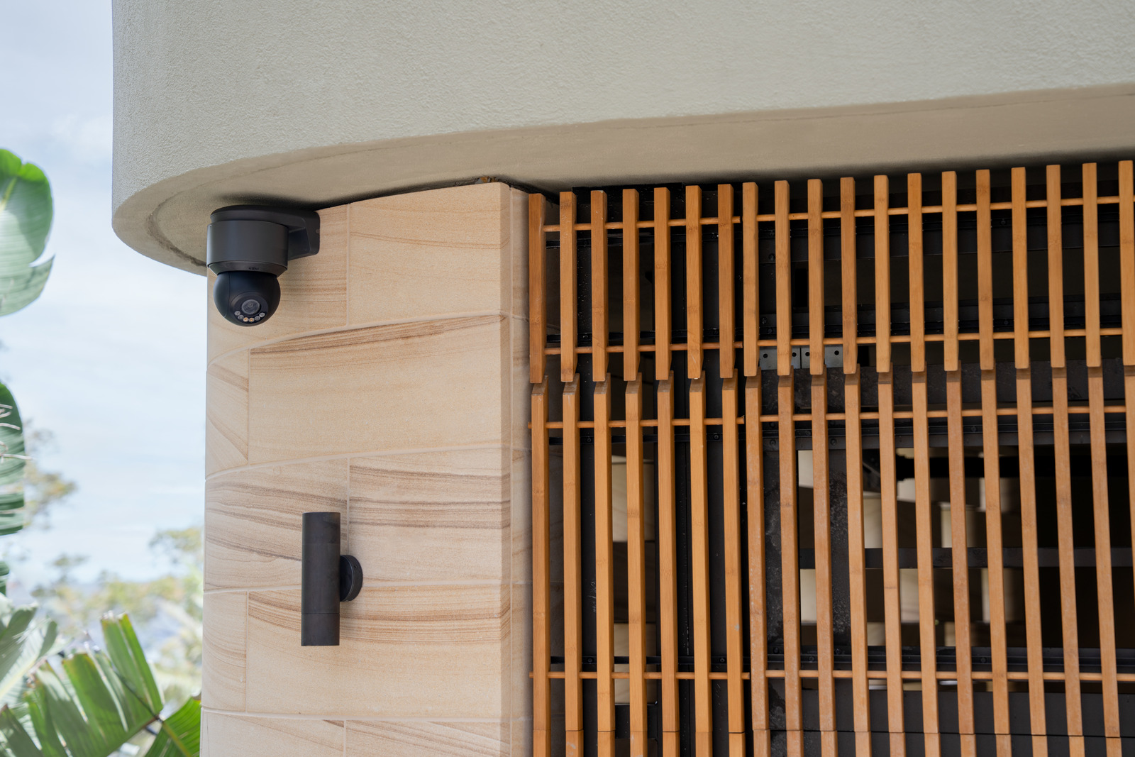 A Luma camera mounted beneath the eave of a wood-clad entrance